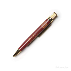 Mark's Days roodbruine balpen met vergulde messing accenten en goudkleurige belettering op de houder.
