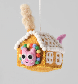 Wrap 'Gretel' viltornament: geel peperkoekhuisje met roze kattengezicht, kleurrijke krans en witte pompons.